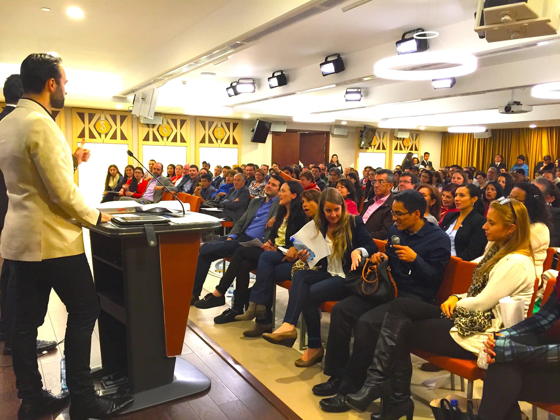 Andrea at the podium in a packed seminar room